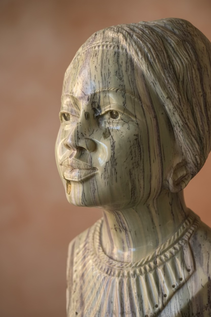 Close profile of The Muse jade stone sculpture with natural veining