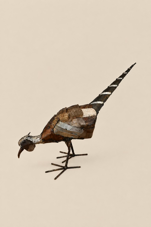 Foraging Pheasant metal sculpture with its head lowered, layered bronze-toned body and long banded tail.