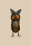 Sentinel Owl metal sculpture with amber-orange eyes and a mesh body, front view.