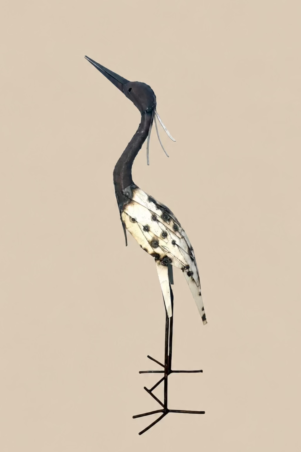 Large Heron viewed from the opposite side, showing its curved neck and layered cream wing.