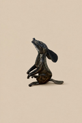 Dark metal Moon Gazing Hare with its head tilted upwards and long ears laid back, in side profile.
