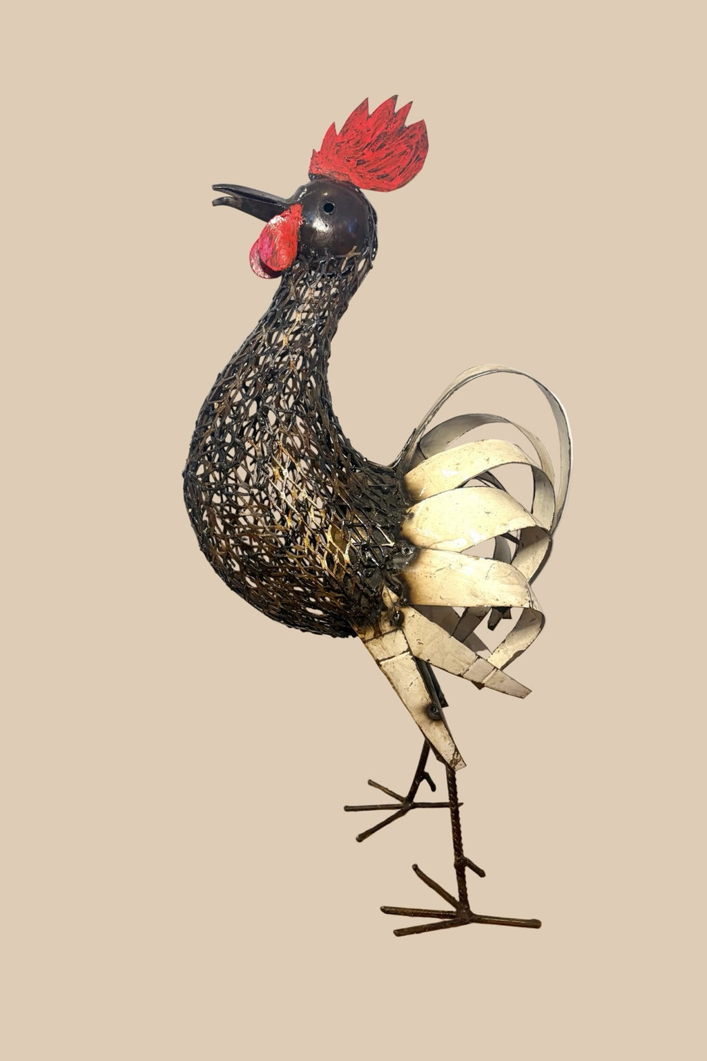 Mesh Cockerel with a red comb, dark wire body and pale curled tail feathers, in side profile.