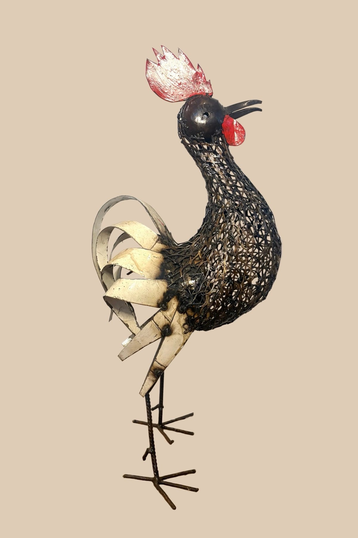 Mesh Cockerel with a red comb, dark wire body and pale curled tail feathers, viewed from the opposite side.