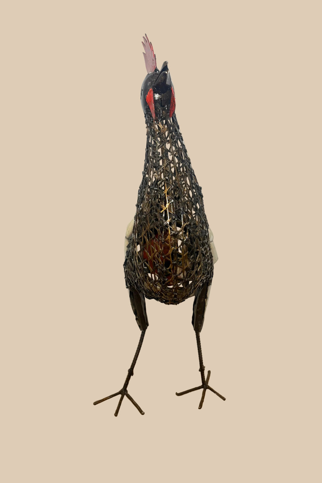 Mesh Cockerel with a red comb, dark wire body and pale curled tail feathers, viewed from the front.