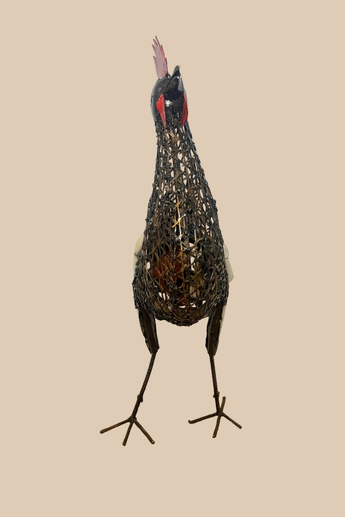 Mesh Cockerel with a red comb, dark wire body and pale curled tail feathers, viewed from the front.