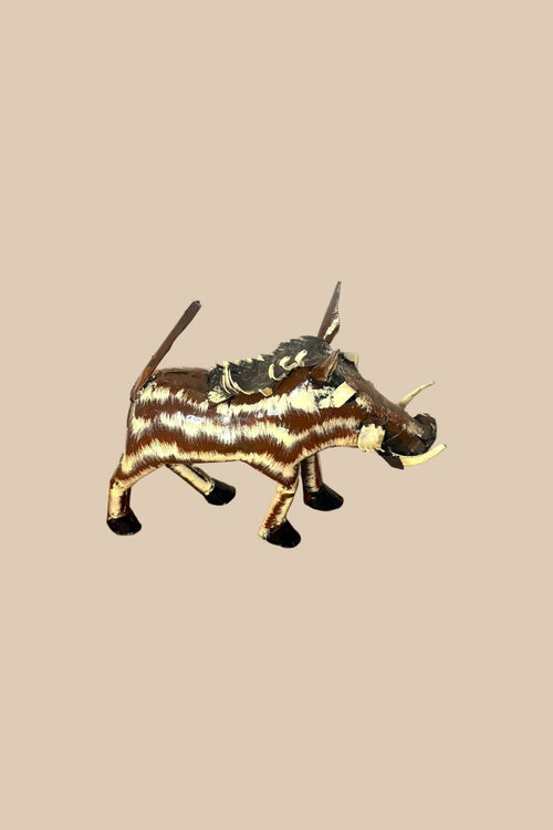 Bristleback Warthog with brown-and-cream stripes, curved tusks and a raised tail, viewed from the opposite side.