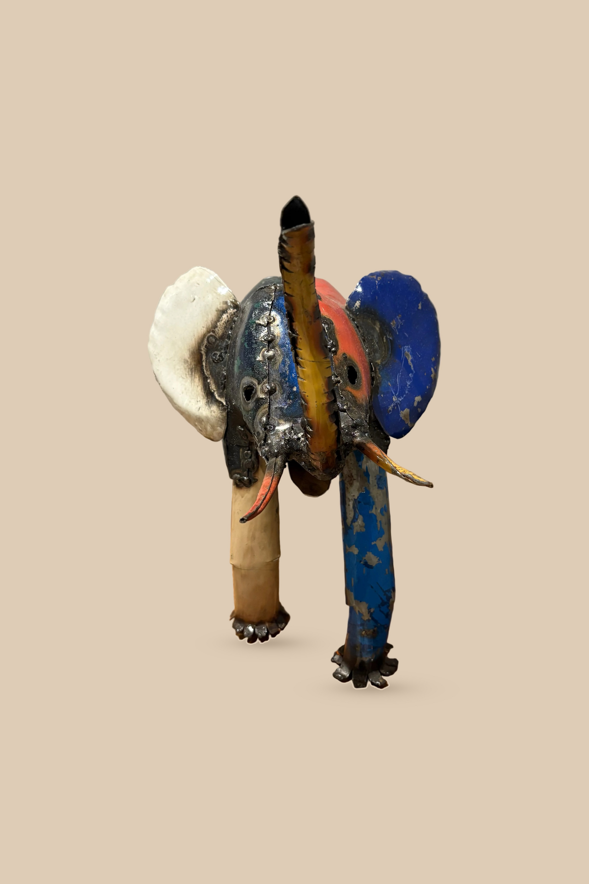 Medium Elephant sculpture in colourful reclaimed metal with a raised trunk, viewed from the front.