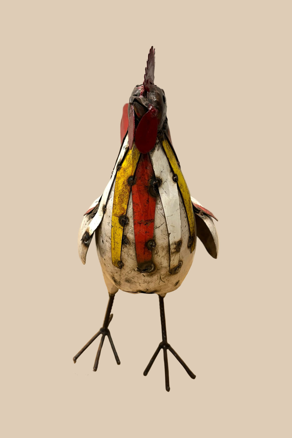 Patchwork Cockerel with a cream body, red tail and colourful neck feathers, viewed from the front.