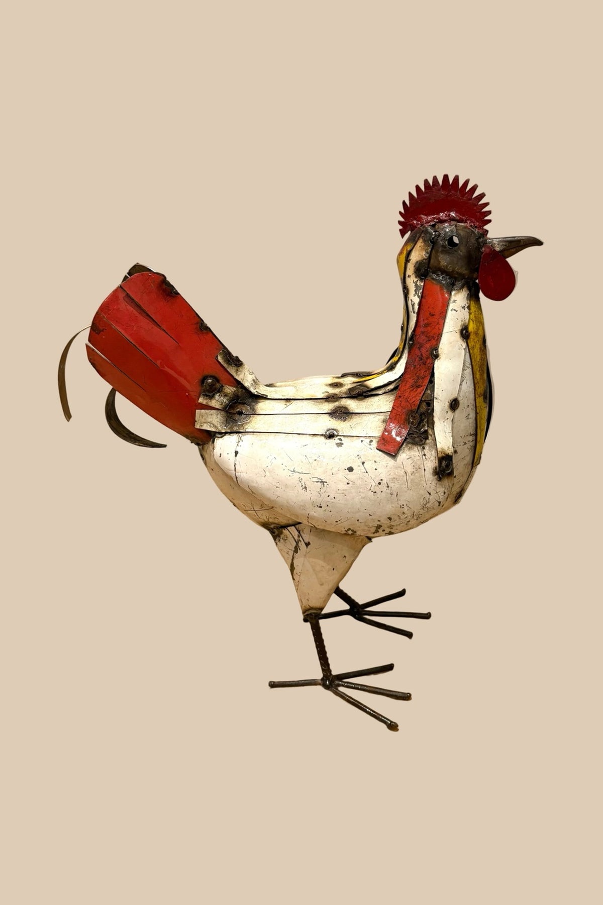 Patchwork Cockerel with a cream body, red tail and colourful neck feathers, viewed from the opposite side.