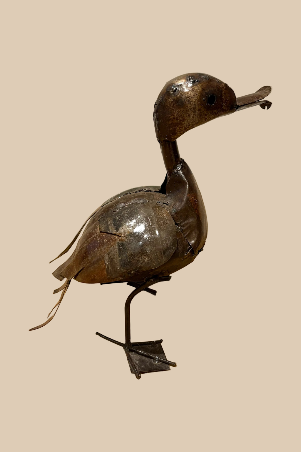 Calling Duck sculpture in dark metal with an open bill and webbed feet, viewed from the opposite side.