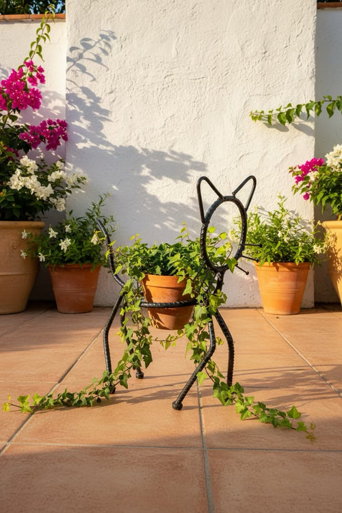 Cat Planter Stand holding trailing ivy on a sunlit patio