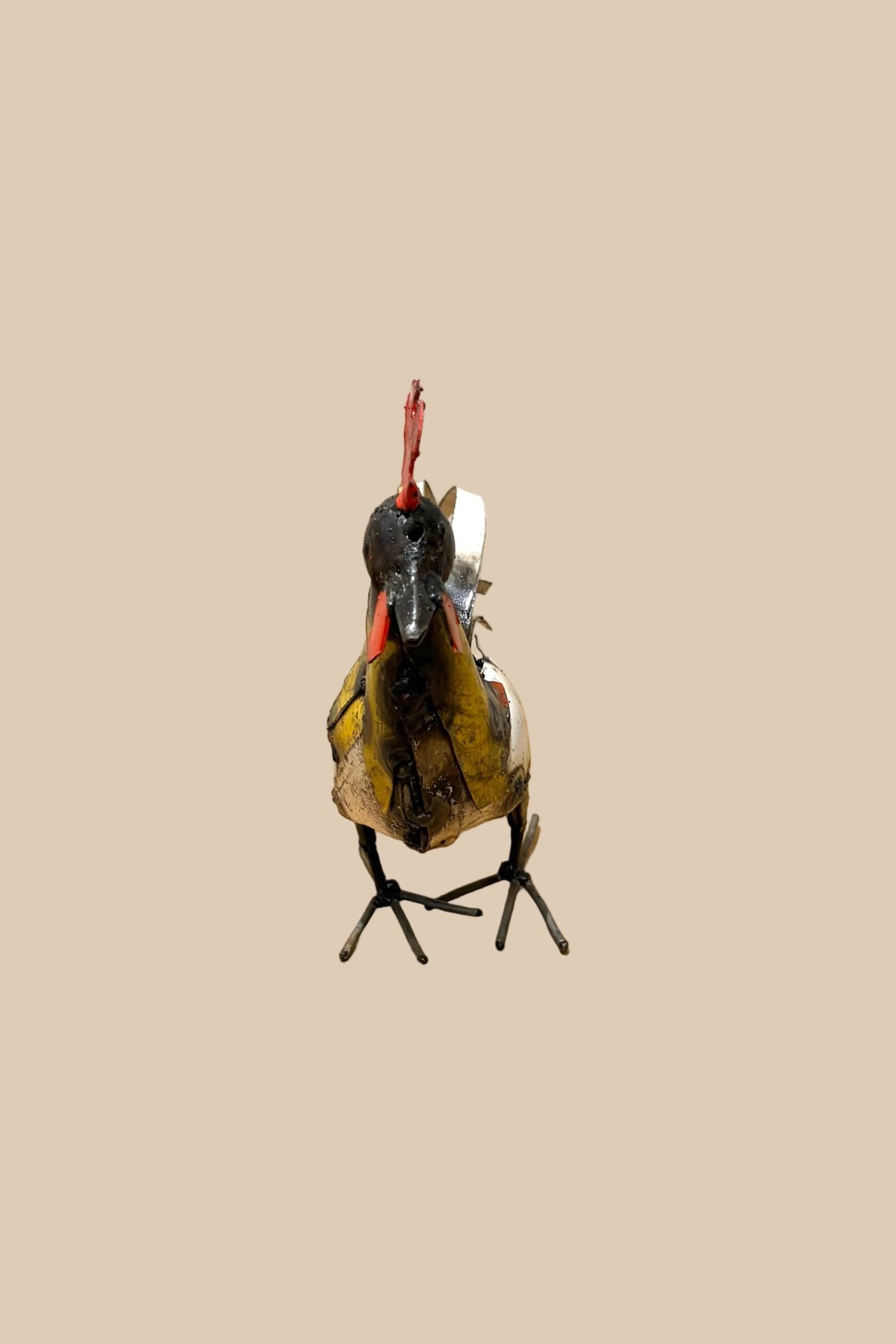 Small Cockerel metal sculpture with a red comb, yellow chest and pale tail feathers, viewed from the front.