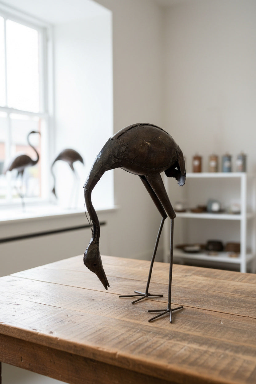 Stooping Stork recycled metal sculpture in a light-filled interior